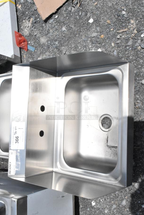 Stainless steel commercial sink, Regency brand, with two mounting holes and overflow drain. Slight surface wear visible.