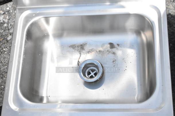 Stainless steel kitchen sink with visible dirt and wear, single basin, includes drain opening, no labels or markings.