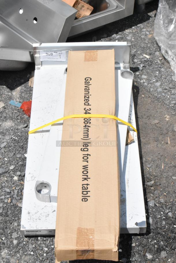 Galvanized 34" (864mm) work table leg package, new condition, with Regency label, suitable for industrial use.