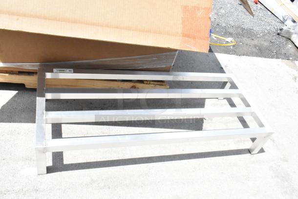Metal pallet with four slats, smooth silver finish, rectangular shape. Label reads "Formaspace." New condition.