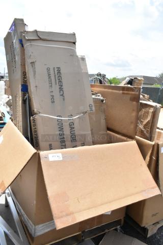 Large, assorted cardboard boxes including a Regency Space Solutions packaging, showing signs of wear and outdoor exposure.