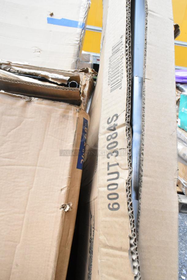 Damaged cardboard boxes with visible code "600UT3084S," indicating possible contents. Boxes show wear and tear.