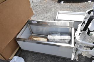 Stainless steel sink basin, new condition, wrapped accessories. Auction tag number 375 attached.