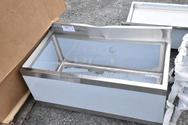 Stainless steel ice bin, used condition, with visible scratches and dents. Label indicates "375 QT". Perfect for commercial use.