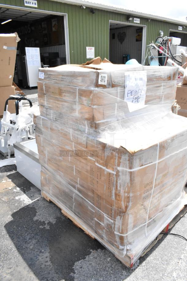 Pallet of boxed items wrapped in plastic, labeled "FED EX" with visible QR code and shipping details, outdoors near warehouse.