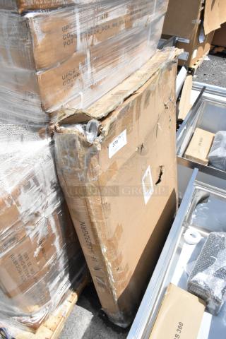 Damaged cardboard box with visible wear and tear, marked "379," containing unknown item. Box displays various shipping labels.