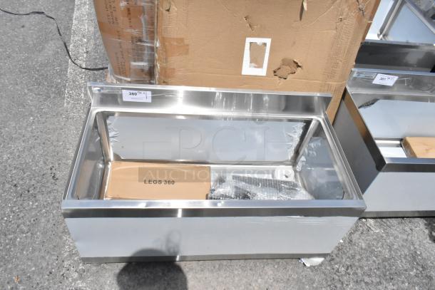 Stainless steel display case with "LEGS 360" box, bubble wrap, and label "380" indicating auction number. New condition.
