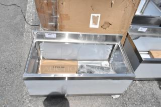 Stainless steel display case with "LEGS 360" box, bubble wrap, and label "380" indicating auction number. New condition.