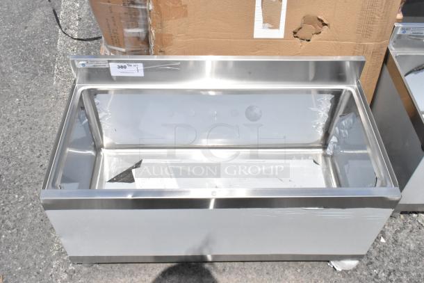 Stainless steel commercial countertop display case with glass panels, minor scratches, price tag displaying "380".