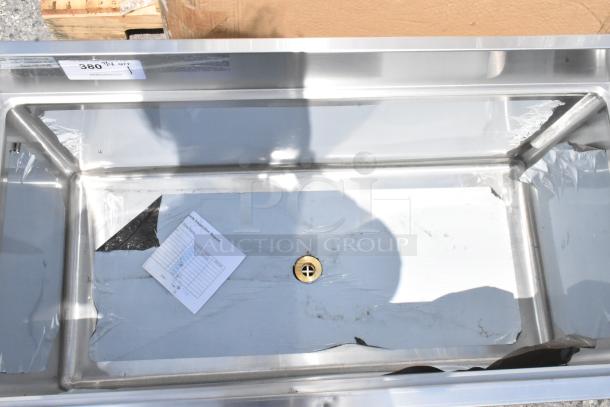 Stainless steel commercial sink with inspection report and protective film, minor scratches, auction tag indicates model 380 1/4.