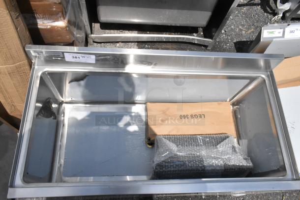 Stainless steel rectangular sink basin, new condition, with protective wrapping. Tag shows "381." Box labeled "LEGS 360."