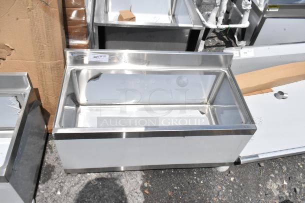 Stainless steel industrial sink, new, with visible labeling "381". Ideal for commercial kitchens.