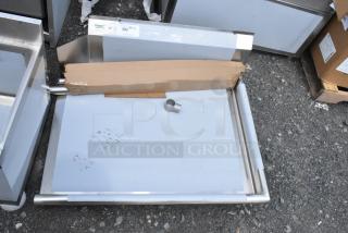 Stainless steel tray with a cardboard package and metal fitting, showing minor wear. Tag indicates "382" quantity label.