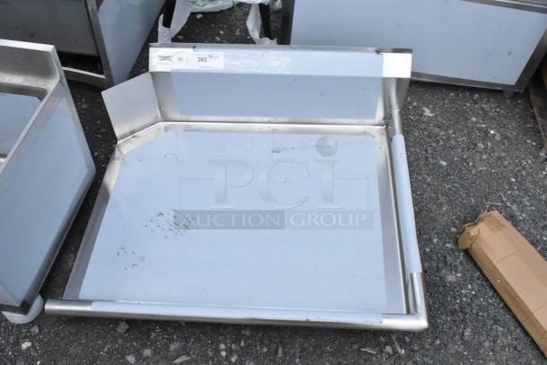 Stainless steel tray with raised edges, minor surface marks, label showing code 382. Ideal for kitchen use.