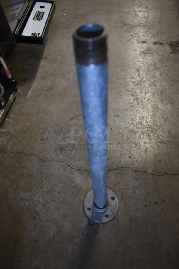 Metal pipe with threaded top, mounted on a circular base. Used condition, suitable for industrial or DIY projects.