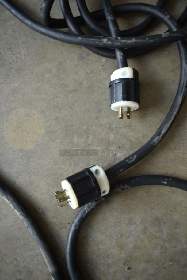 Heavy-duty extension cord with black exterior and industrial connectors, showing wear. Ideal for robust electrical needs.
