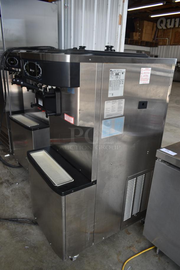 Stainless steel commercial soft serve ice cream machine, dual dispenser, model label with specifications visible, clean condition.