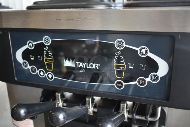 Taylor ice cream machine control panel, black with labeled buttons for settings, lever handles below, in good condition.