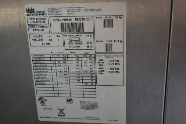 Label on Taylor Crown ice cream maker model C713-33; details power, voltage, refrigerant type, and pressure specifications.