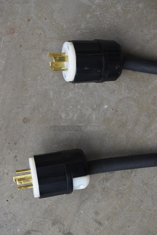 Heavy-duty electrical extension cord with industrial-grade prongs. Black casing, minimal wear. Ideal for power tools.