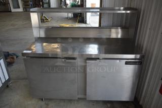 Stainless steel Continental refrigerated prep table with double doors and upper shelf, good condition, item tag "110" visible.
