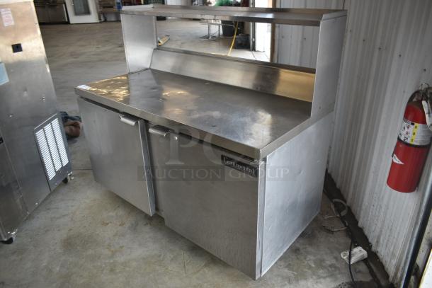 Stainless steel Continental refrigerator prep table with two doors, shelf, and nameplate. In used condition.