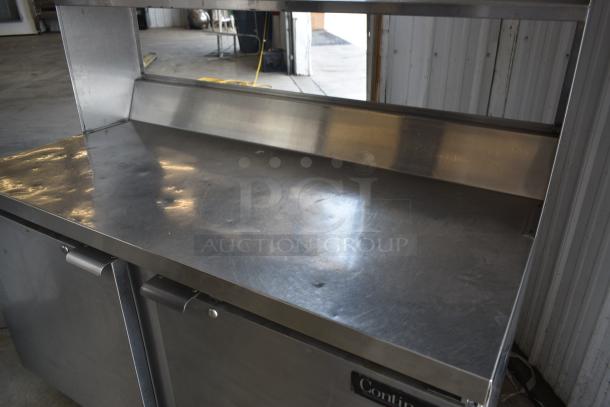 Stainless steel commercial kitchen work table with backsplash, dual cabinet doors, and "Continental" label, in good condition.