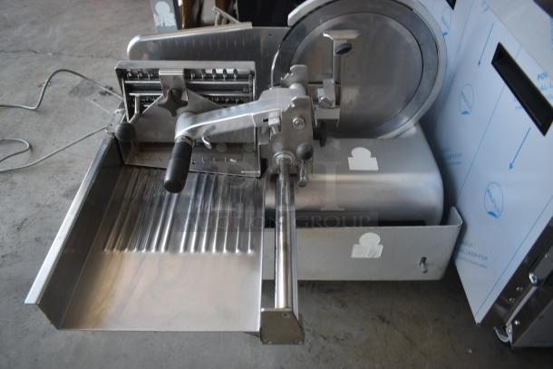 Commercial deli slicer with stainless steel construction, manual crank, and precision blade. Excellent condition.