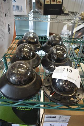 Set of Revo dome security cameras on a shelf, some with tag 113. Visible wear, suitable for surveillance installations.