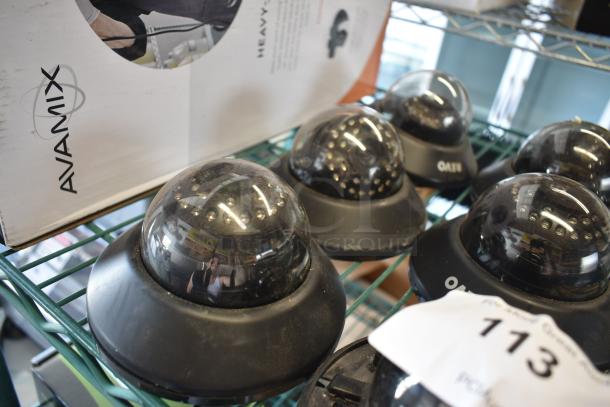 Auction lot of six Avamix dome security cameras, minor wear, model OAT11, auction tag number 113 visible.
