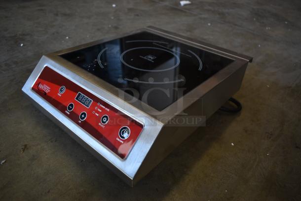 Countertop induction cooker with black glass top and stainless steel frame. Features digital controls, timer, and temperature settings. Brand markings visible. Good condition.