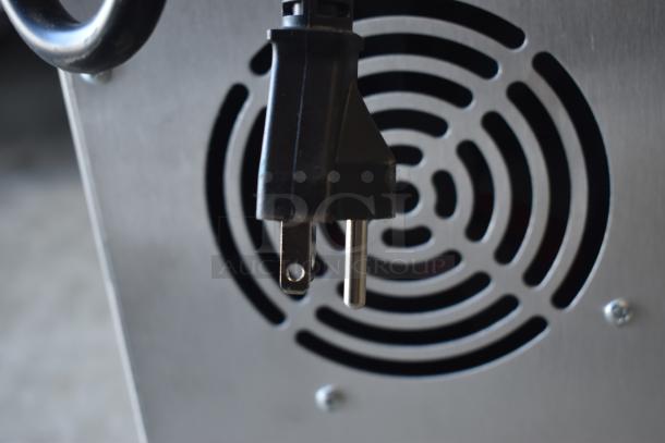 Close-up of a metal appliance with a fan vent and power plug. Features a sleek stainless steel finish. Appears in good condition.