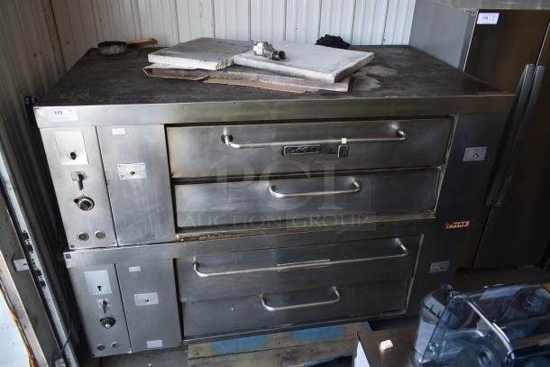 Commercial stainless steel pizza oven with twin stacked compartments, visible wear, control knobs, and auction tag "115."