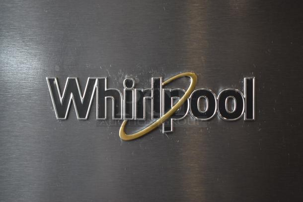Whirlpool logo on stainless steel appliance, showing moderate wear, suggesting a used condition.
