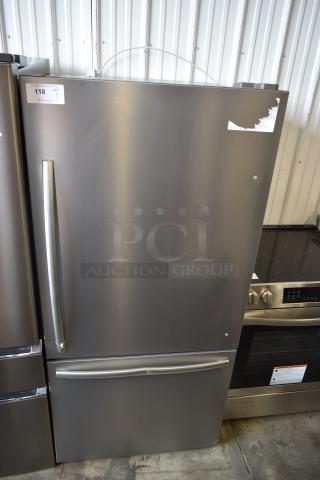 Stainless steel refrigerator with bottom freezer, long handles, good condition, auction tag reading "118 QTY 1".