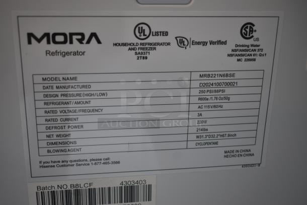 Mora refrigerator model MRB221N6BSE label with specifications; weight 214lbs, dimensions W31.3"xD32.2"xH67.9", made in China.