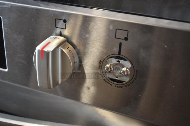 Stainless steel stove control panel with knob, showing "Off" and settings. Markings include "A20287705 Ez Care Stainless."