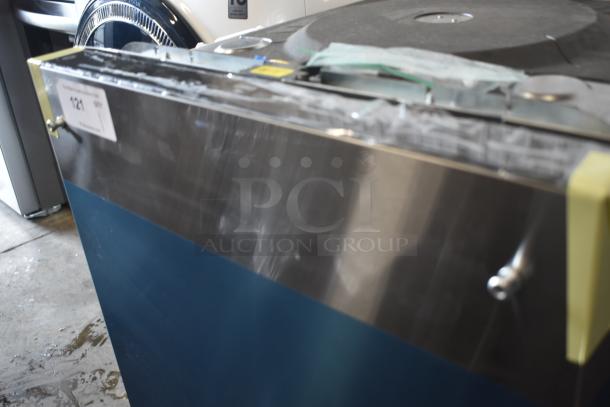 Industrial washer, stainless steel with blue panel, good condition. Auction tag "121" visible.