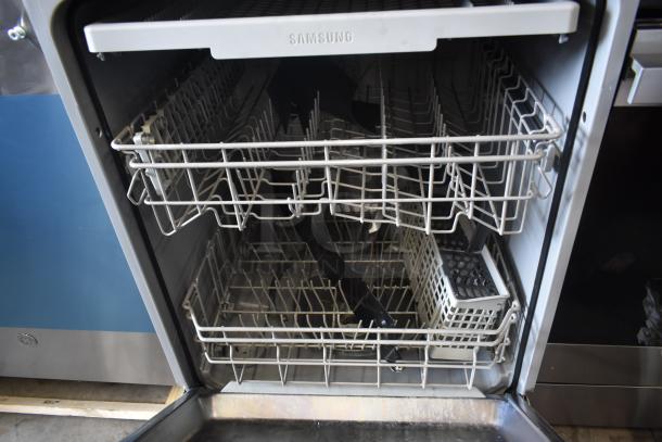 Samsung dishwasher interior, features adjustable racks and cutlery basket. Clean, gently used condition, model label visible.