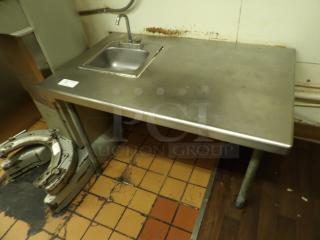 Stainless Steel table with hand sink and faucet. Uneven legs because of step in floor.