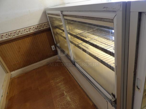 One Structural Concepts Curved Glass Refrigerated Bakery Display Case. 220 Volt. Curved Glass In Front, With 2 Rear Slide Doors, Lighted Donut Display Case, 4 Rack Powers on and works as should - Image 4 of 5
