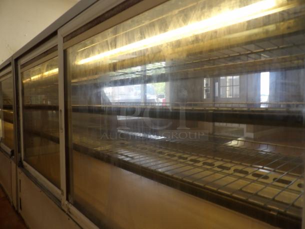One Structural Concepts Curved Glass Refrigerated Bakery Display Case. 220 Volt. Curved Glass In Front, With 2 Rear Slide Doors, Lighted Donut Display Case, 4 Rack Powers on and works as should - Image 5 of 5