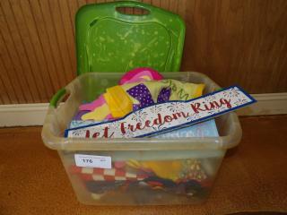 Clear plastic bin with assorted felt crafts, fabric decor, and a "Let Freedom Ring" sign, marked with auction label 176.
