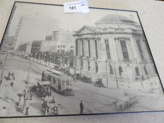 Framed vintage photograph of an early 20th-century urban scene featuring a historic domed building and streetcars. Auction tag 181.