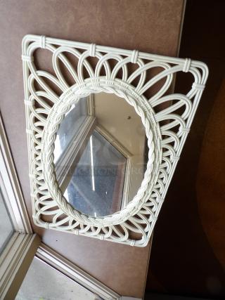 Vintage oval mirror with intricate white wicker frame, excellent condition, unique decorative wall piece.