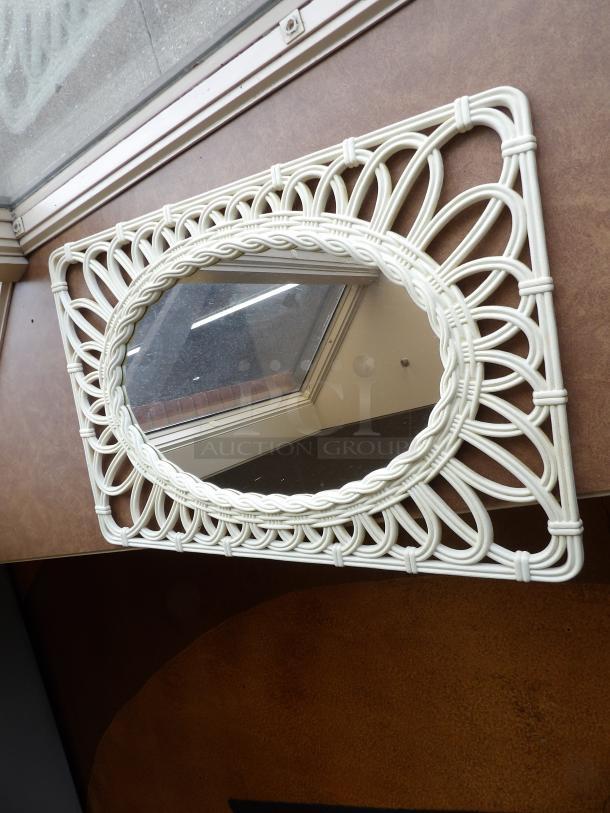 Oval mirror with intricate white wicker frame, showcasing a vintage design. Excellent condition, no visible labels or markings.