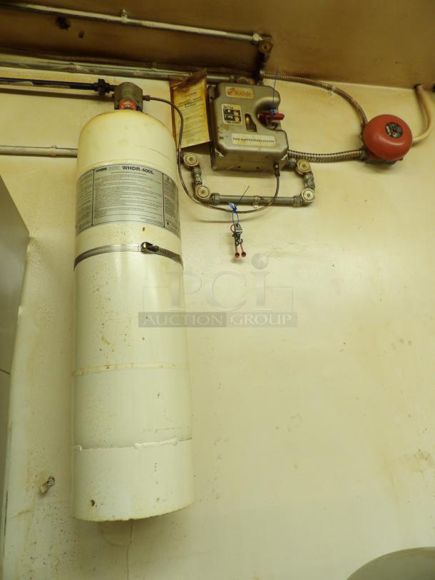 Kidde WHDR-400L fire suppression system, mounted. Visible wear, labels detail usage and maintenance.