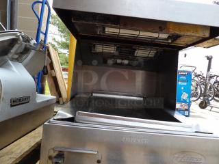 Hatco commercial toaster, stainless steel, visible wear, "Caution Hot" label, alongside Hobart equipment.