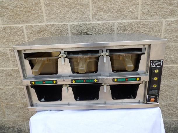 Duke four-slot food warmer, stainless steel, with labeled controls, good condition, ideal for commercial kitchens.