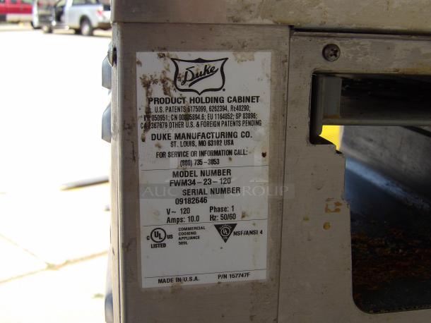 Duke Manufacturing product holding cabinet label, model FWM34-23-120, serial 09182646, 120V, 10A, UL listed, made in USA.